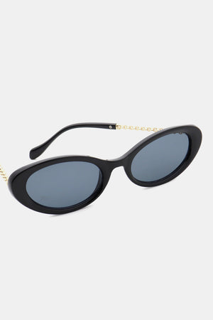 Black oval sunglasses with gold chain detail on the temples.