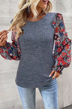 Dark gray knit top with floral chiffon puff sleeves and ruffled cuffs.