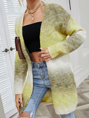 Rainbow gradient knit cardigan with pockets, open front, long sleeves, and a relaxed fit.