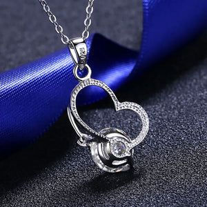 Silver heart halo pendant necklace with a clear crystal accent.