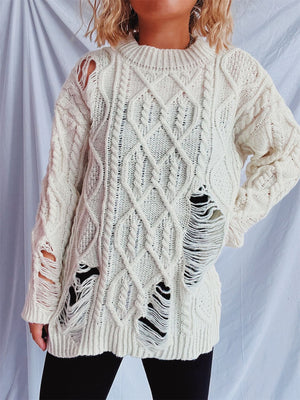 White distressed cable knit sweater with ripped details and crew neck.