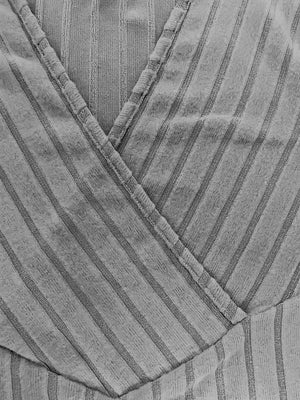 Gray ribbed wrap top with plunging neckline and vertical stripe detail.