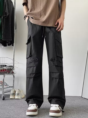 Black wide-leg cargo pants with multiple flap pockets and button details.