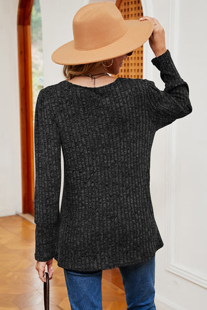 Black ribbed button-down top with asymmetric hem, long sleeves, and crew neck.