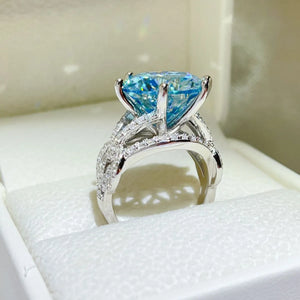Celestial blue moissanite knot ring with pave diamond band.