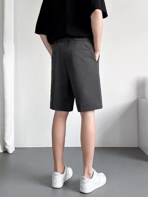 Men's dark gray belted chino shorts with a relaxed fit and pockets.