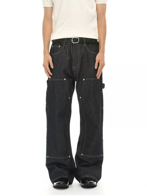 Dark wash cotton blend carpenter jeans with contrast stitching and distinctive pockets.