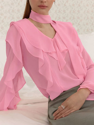 Pink chiffon blouse with V-neck, ruffle trim, and tie detail.
