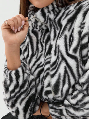 Plush cropped jacket with black and white zebra print, featuring a drawstring closure.