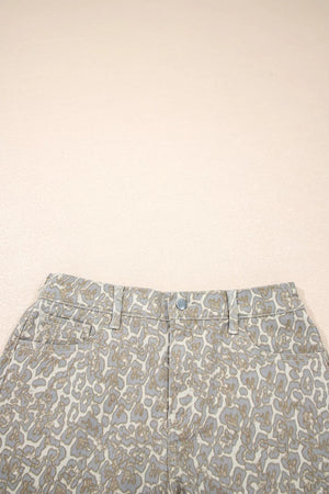 Denim shorts with a subtle leopard print in grey and tan, featuring a button fly and front pockets.