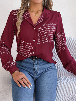Burgundy collared blouse with white script pattern, button front, and long sleeves.