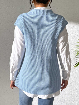 Light blue ribbed knit vest with a mock neck, styled over a white shirt.