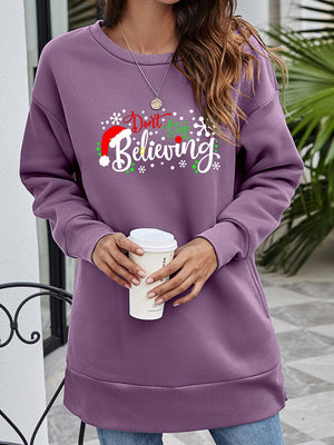 Purple graphic tunic sweatshirt with "Don't Stop Believing" holiday print and crew neck.