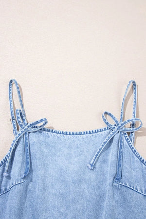 Light blue denim sundress with tie shoulder straps and ruffled hem detail.