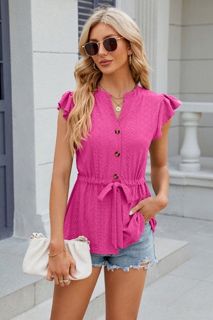 Hot Pink textured eyelet peplum blouse with tie waist and flutter sleeves.