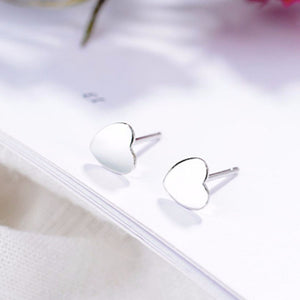 Elegant heart-shaped sterling silver stud earrings with butterfly backs.
