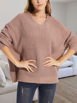 Dusty Pink ribbed knit batwing sweater with V-neck, relaxed fit, and acrylic blend.