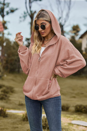 Dusty pink textured cable knit zip-up hoodie with a drawstring hood and pockets.