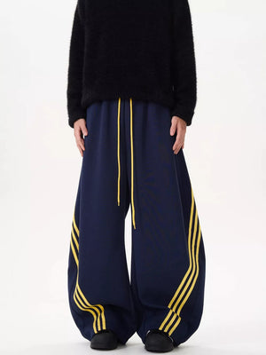 Navy wide-leg sweatpants with yellow stripes and drawstring waist