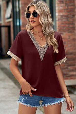 Burgundy V-neck blouse with lace trim on neckline and sleeves