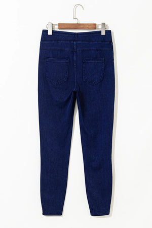 Dark wash denim jeggings with faux pockets and a slim fit.