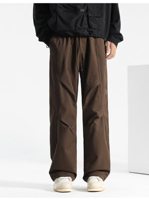 Brown drawstring sweatpants with a relaxed fit and unique paneling details.