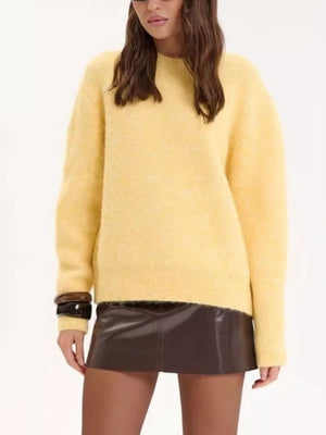 Cozy knit sweater in pastel yellow with relaxed fit, crew neck, and long sleeves.