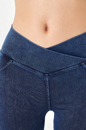 Denim bermuda shorts in dark blue with a crisscross waistband detail.