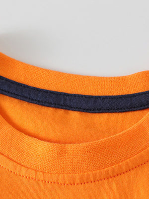 Toddler orange cotton graphic tee with navy trim at neckline