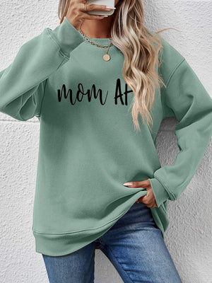 Sage green crewneck sweatshirt with black "Mom AF" graphic, relaxed fit.