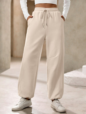 Tan balloon-leg sweatpants with drawstring waist and pockets