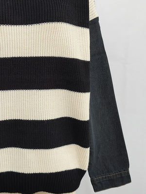 Black and cream striped knit sweater with black denim sleeves.