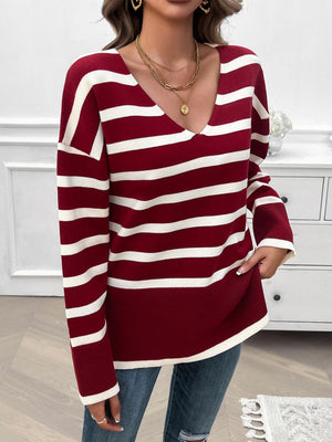 Burgundy and white striped oversized V-neck knit sweater with long sleeves.