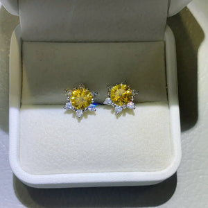 Golden sunburst moissanite stud earrings in 925 sterling silver with clear accent stones.