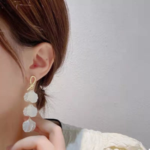 Elegant beige shell drop earrings with gold loop detail.