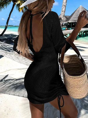 Black diamond knit backless beach mini dress with drawstring sides and halter neck.