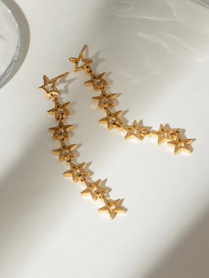 Gold celestial star dangle earrings with multiple stars cascading down.
