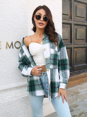 Oversized green plaid shacket with gold buttons, worn open over a white top.