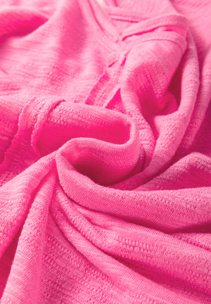 Hot pink V-neck blouse with textured fabric and contrast panel detail