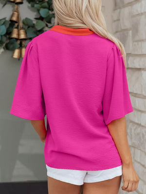 Textured pink V-neck blouse with half sleeves and orange collar detail.