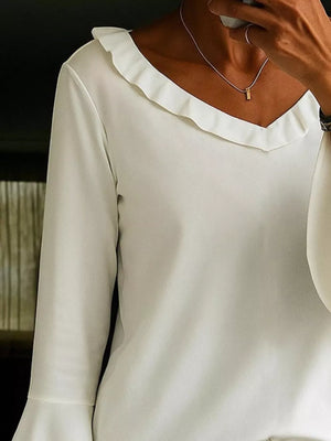 White polyester blouse with ruffled V-neck and bell sleeves.