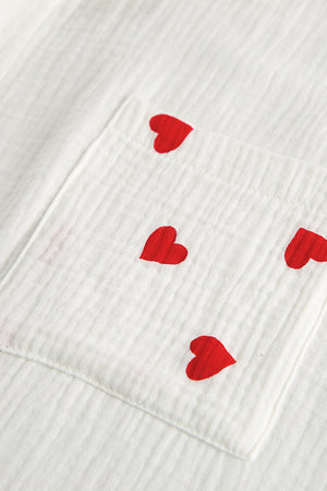 White gauze pajama top with red heart print and chest pocket detail.