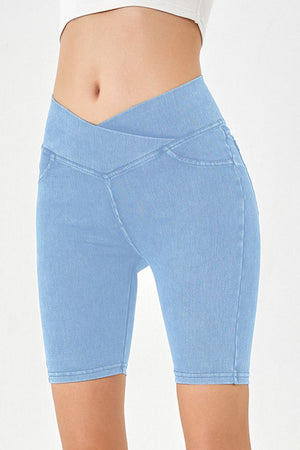 Light blue denim bermuda shorts with a crisscross waistband and a casual cut.