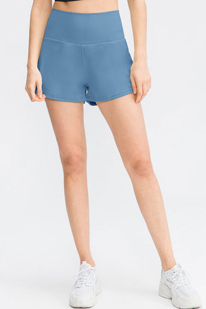 Sculpted high-waist active shorts in Light Blue with a V-cut hem.
