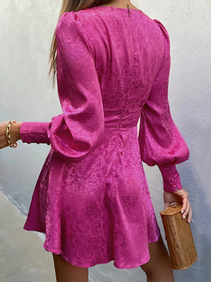 Vibrant cerise mini dress with jacquard floral pattern, deep V-neck, and voluminous lantern sleeves.