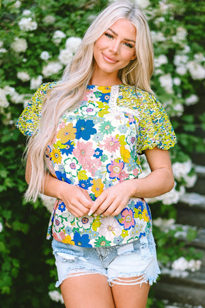 Floral patchwork puff sleeve blouse with crochet trim and mixed floral prints.