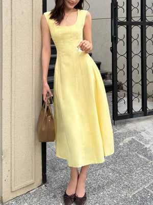 Sleeveless yellow a-line midi dress with square neckline and subtle vertical seams.