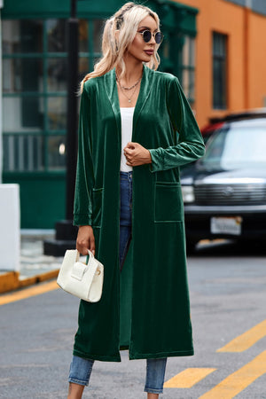 Dark green velvet duster coat with pockets, open front, long sleeves, and a relaxed fit.