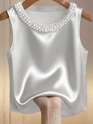 White satin tank top with pearl embellished neckline.