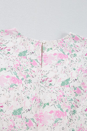 Blush pink floral print blouse with smocked waist detail and button closure at back neck.